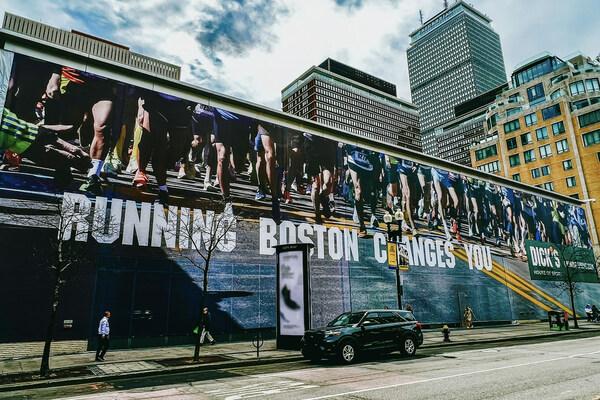 A banner with the tagline "Running Boston Changes You" has been placed on the future location of Dick’s House of Sport in Boston.